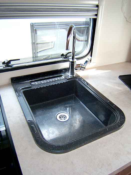 The sink with swan neck mixer tap.